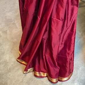 Brand new maroon color saree with traditional peacock design border in gold.